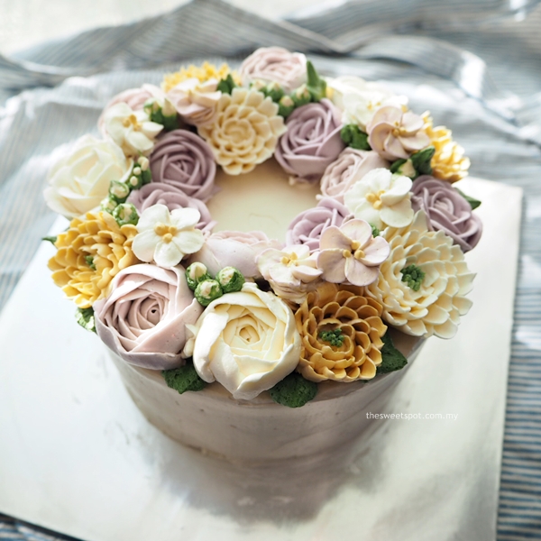 purple and yellow buttercream wreath cake
